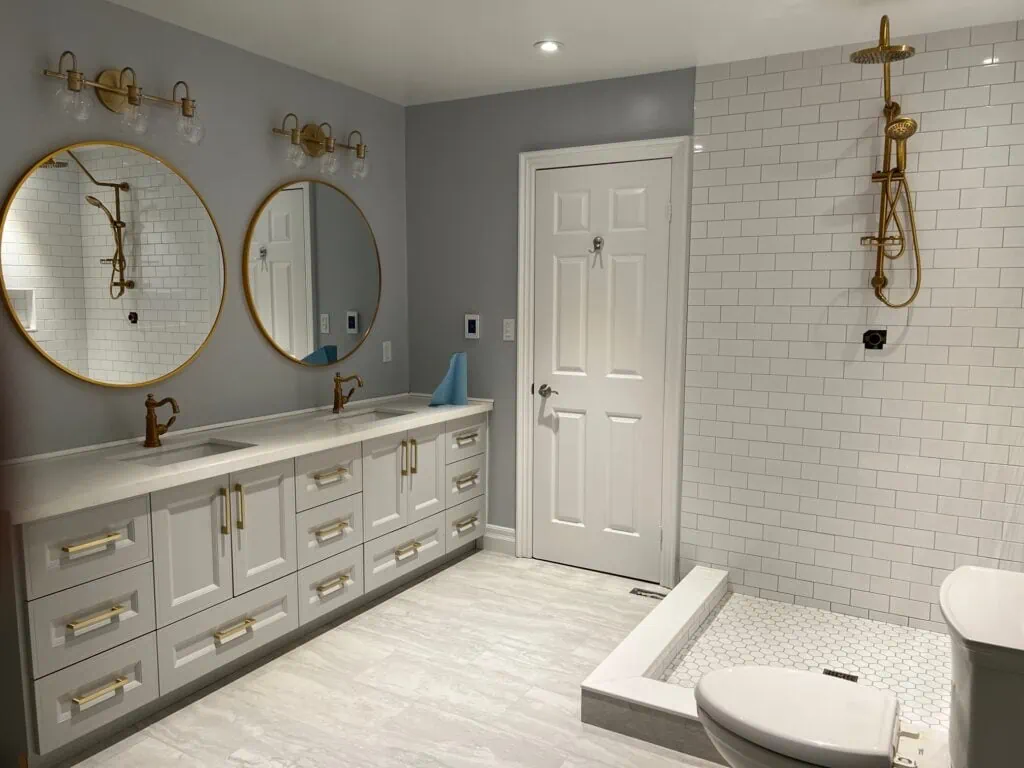 newly renovated bathroom with white vanity and countertop