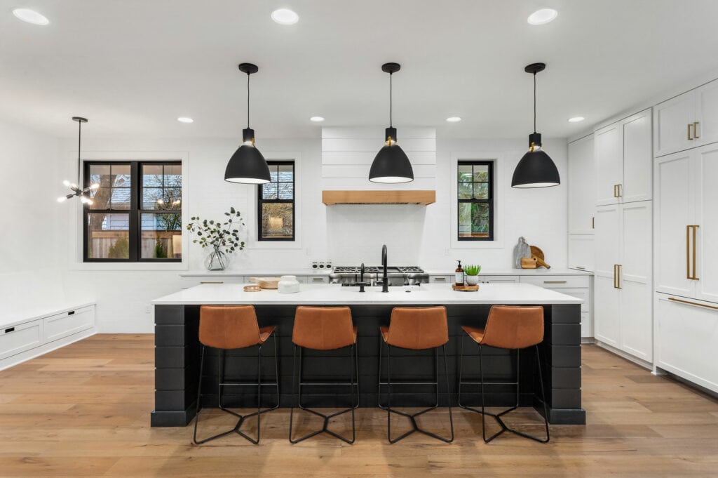 modern kitchen with an island, bar stools, and lots of lighting