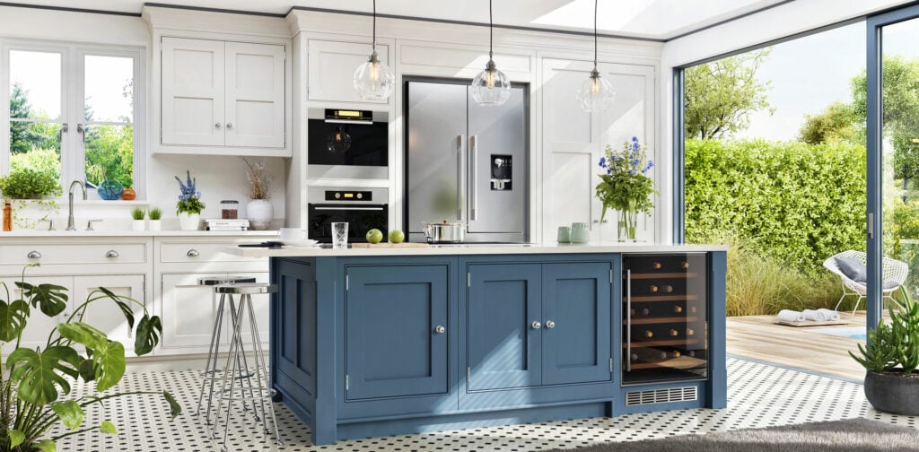 Kitchen renovation featuring a blue-cabinet island, white countertops, greenery, a walk-out patio deck with a glass wall