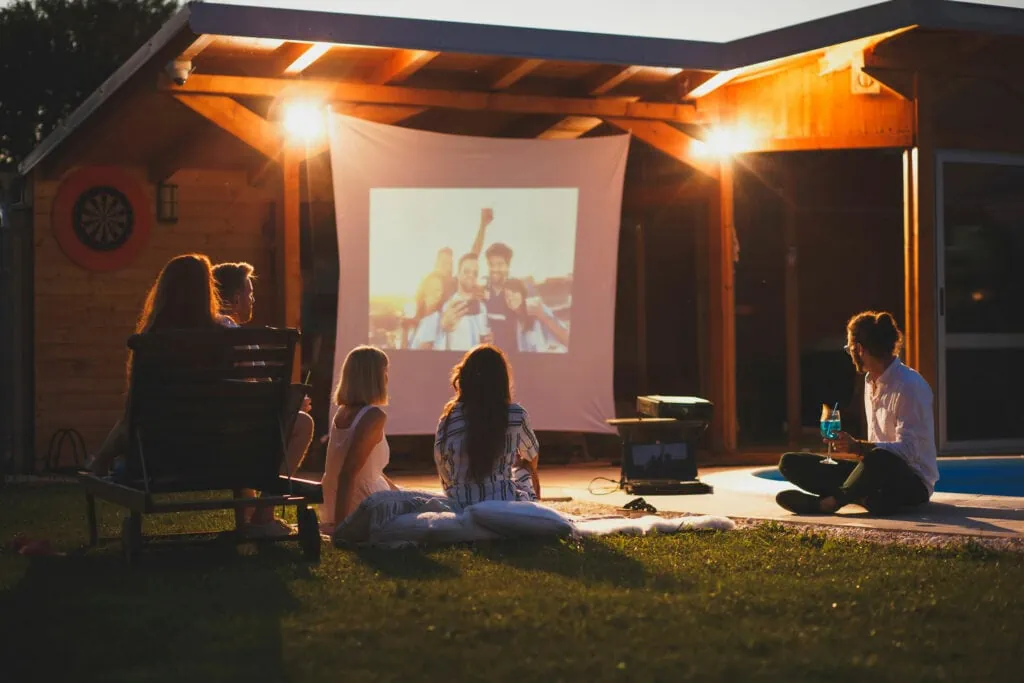 family watching a movie in the backyard